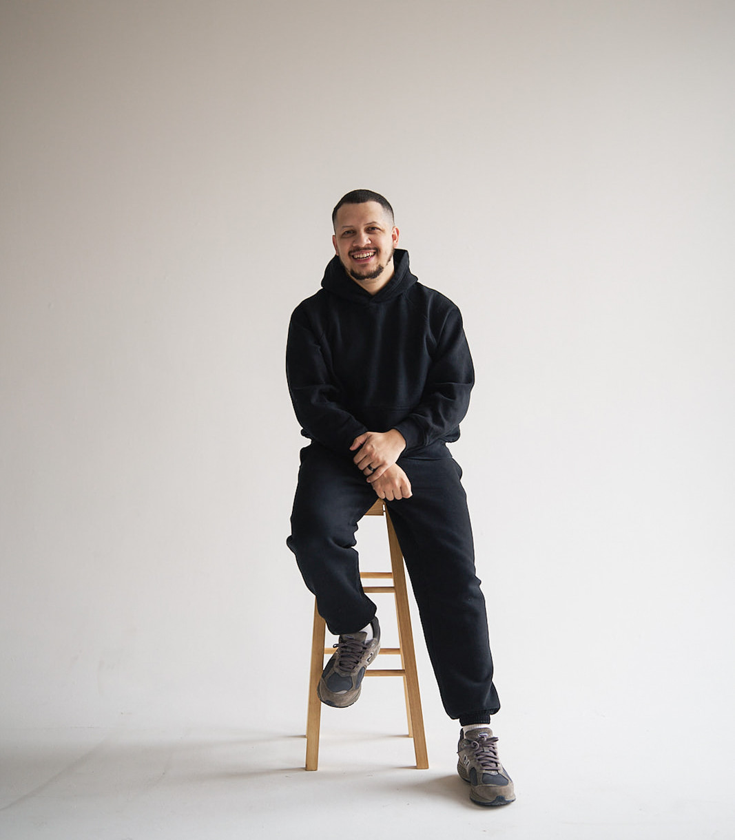 Ayodiran Fabian smiling while seated in a photography studio
